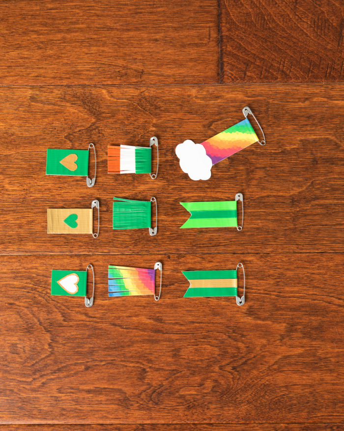 Nine St Patricks Day pins made with colored duck tape