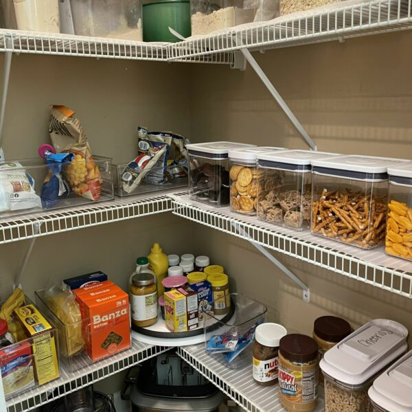 Home pantry with food on shelves.