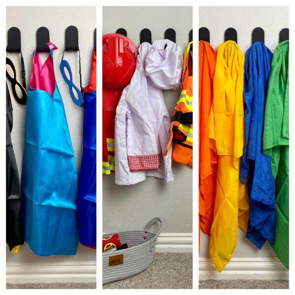 Kids costumes hanging on hooks.